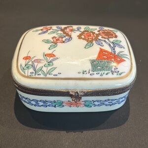 B Altman & Co. Painted porcelain box with ornate bronze surround.